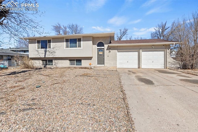 split level home with a garage and concrete driveway