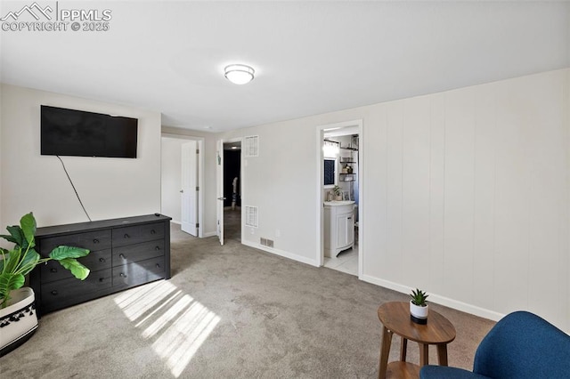 interior space featuring light carpet, visible vents, and baseboards