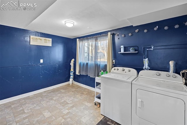 laundry room featuring laundry area, baseboards, and washer and clothes dryer