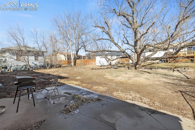 view of yard with a residential view, fence, and a patio