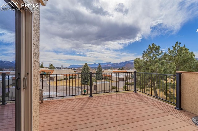 wooden deck with a mountain view