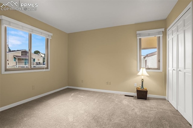 interior space featuring visible vents, baseboards, and carpet flooring