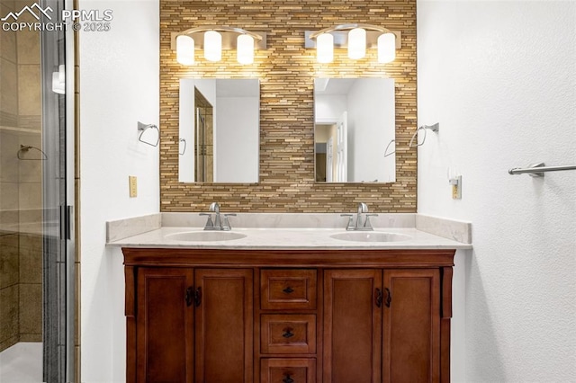 full bath featuring double vanity, a stall shower, a sink, and decorative backsplash