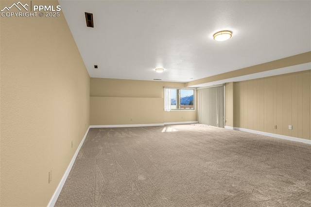 unfurnished room with carpet flooring and baseboards