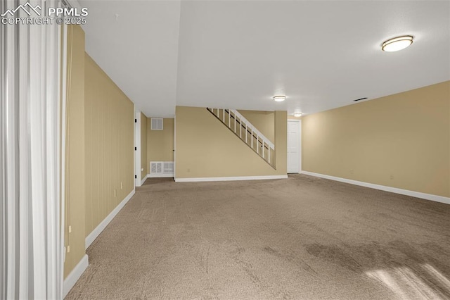 interior space featuring stairway, carpet flooring, visible vents, and baseboards