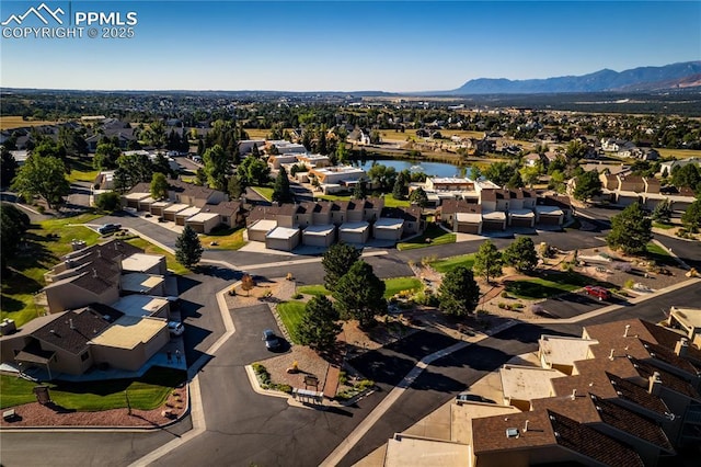 aerial view featuring a residential view and a water and mountain view