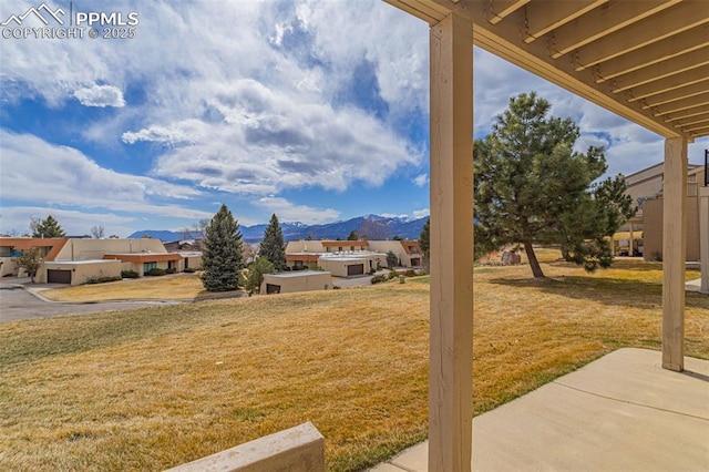 view of yard with a residential view and a mountain view