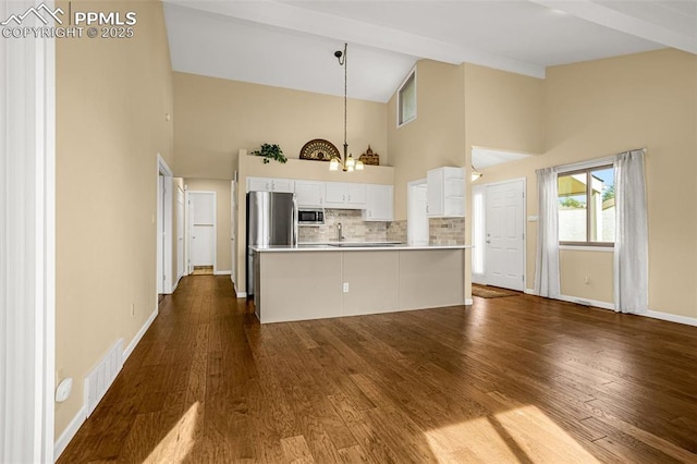 kitchen with stainless steel appliances, tasteful backsplash, visible vents, dark wood-type flooring, and white cabinets