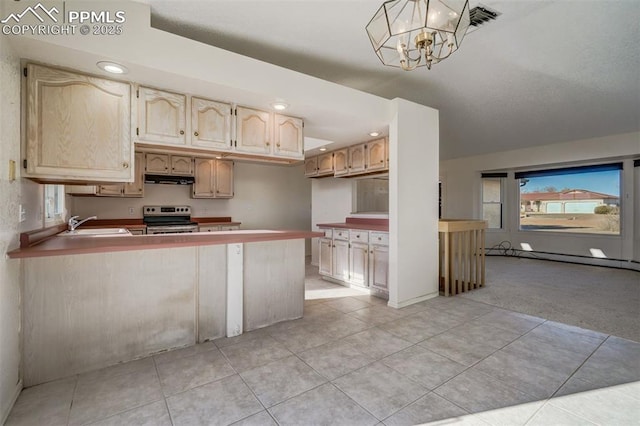 kitchen with electric stove, pendant lighting, a baseboard radiator, a sink, and a peninsula