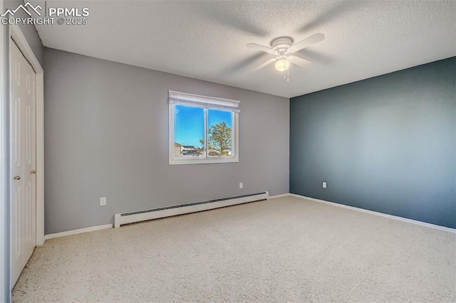 empty room featuring a baseboard heating unit, ceiling fan, a textured ceiling, and baseboards