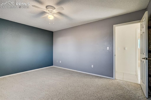 unfurnished room featuring a ceiling fan, carpet, and a textured ceiling