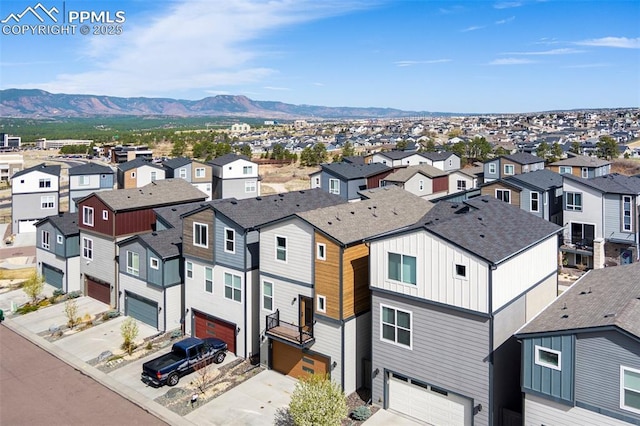 drone / aerial view featuring a residential view and a mountain view