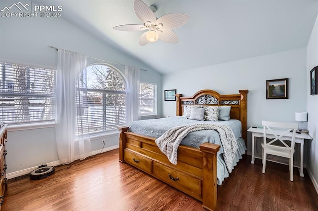 bedroom featuring vaulted ceiling, wood finished floors, and baseboards