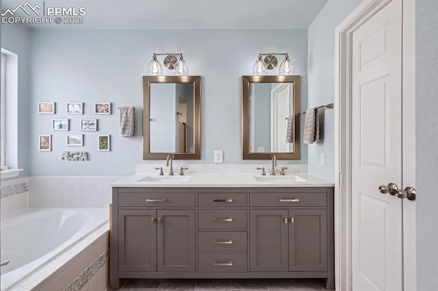 full bath featuring a bath, double vanity, and a sink