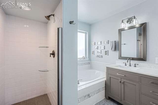 full bath with a garden tub, a tile shower, and vanity