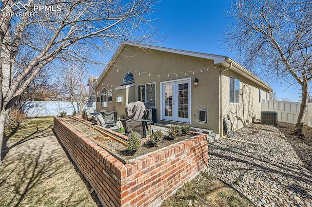 back of house featuring french doors, central air condition unit, stucco siding, a patio area, and fence