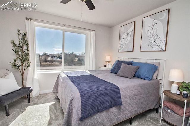 carpeted bedroom featuring a ceiling fan and baseboards