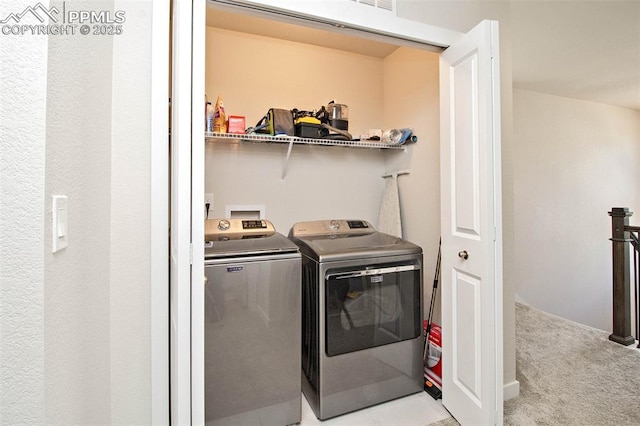 laundry room featuring laundry area, light colored carpet, and independent washer and dryer