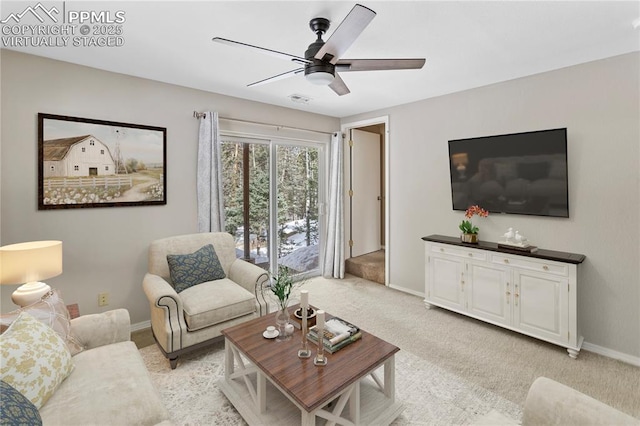 living room featuring light carpet, a ceiling fan, visible vents, baseboards, and stairway