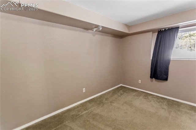 spare room with carpet and baseboards