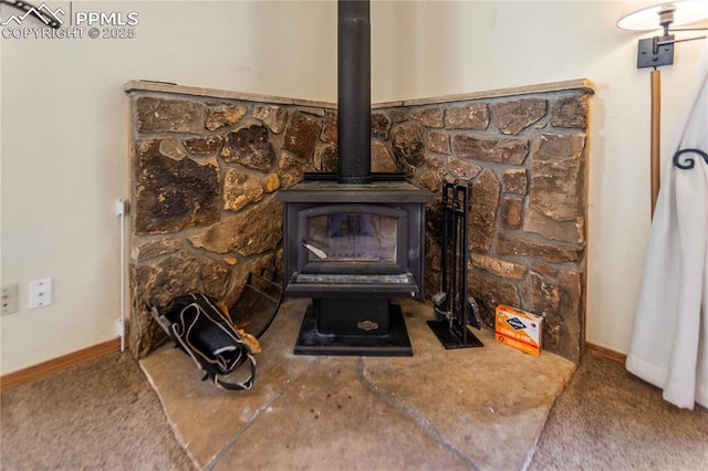 details with carpet floors, a wood stove, and baseboards