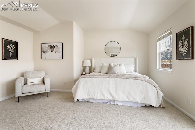 bedroom with lofted ceiling, carpet floors, and baseboards