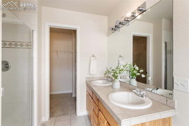 full bathroom with tile patterned flooring, a shower stall, and a sink