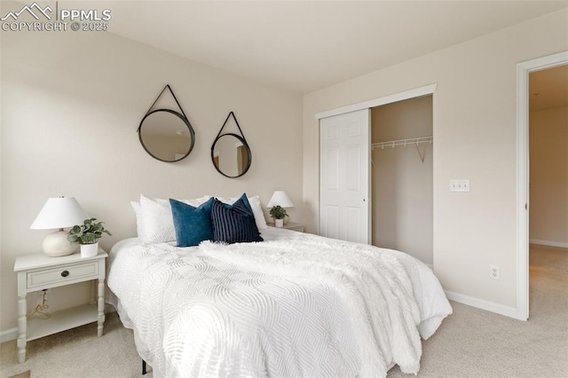 bedroom featuring baseboards, a closet, and light colored carpet