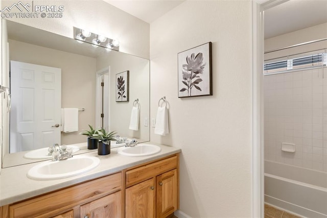 bathroom featuring double vanity, a sink, and shower / bathtub combination