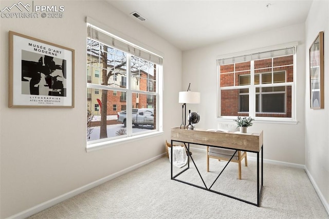 carpeted home office featuring visible vents and baseboards