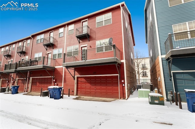 view of front of home featuring a garage and central AC unit