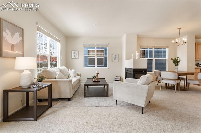 living area featuring a notable chandelier and light colored carpet