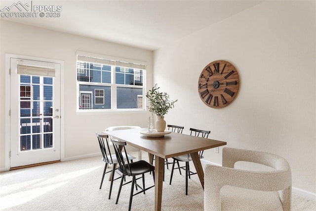 dining area featuring carpet and baseboards