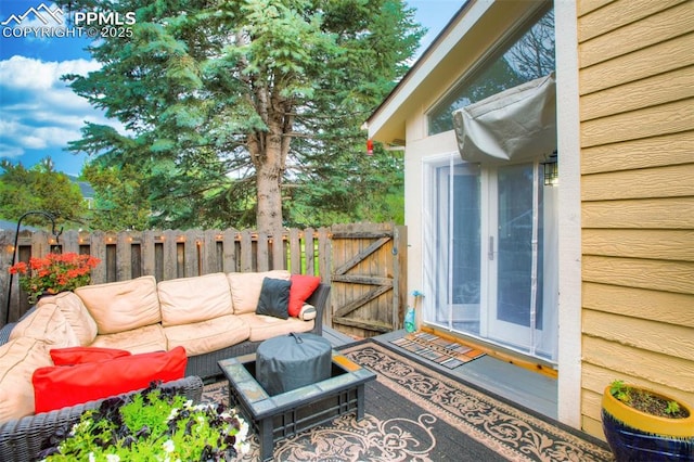 exterior space with a gate, fence, and an outdoor hangout area