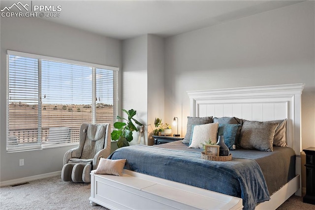 carpeted bedroom featuring visible vents and baseboards