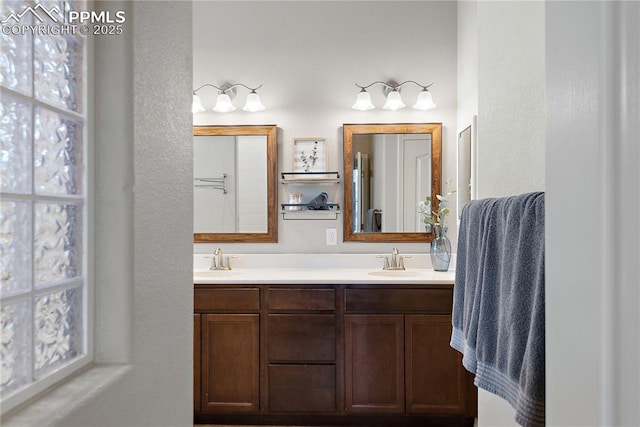 bathroom featuring a sink and double vanity