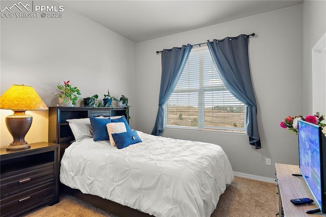 carpeted bedroom featuring baseboards