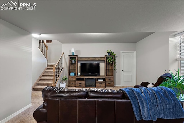 carpeted living room with stairs and baseboards