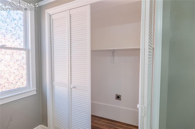 laundry area featuring laundry area, hookup for an electric dryer, and dark wood-style flooring