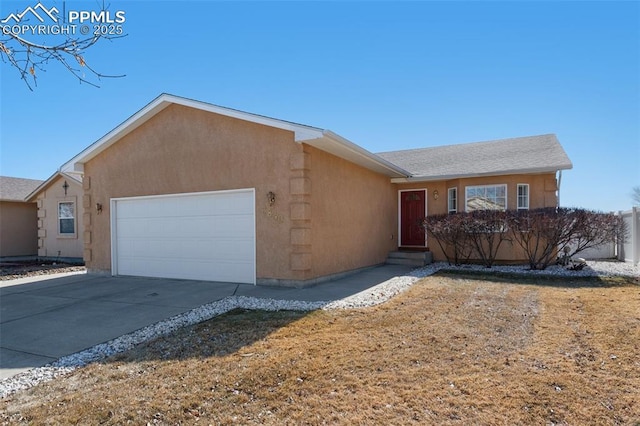 single story home with entry steps, concrete driveway, an attached garage, and stucco siding