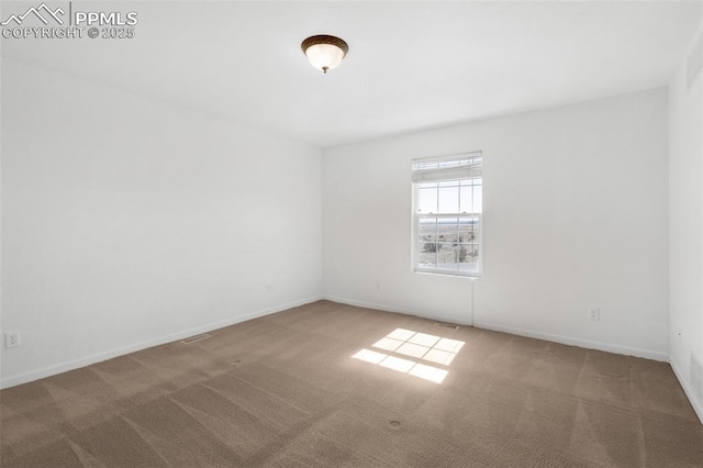 carpeted empty room with baseboards