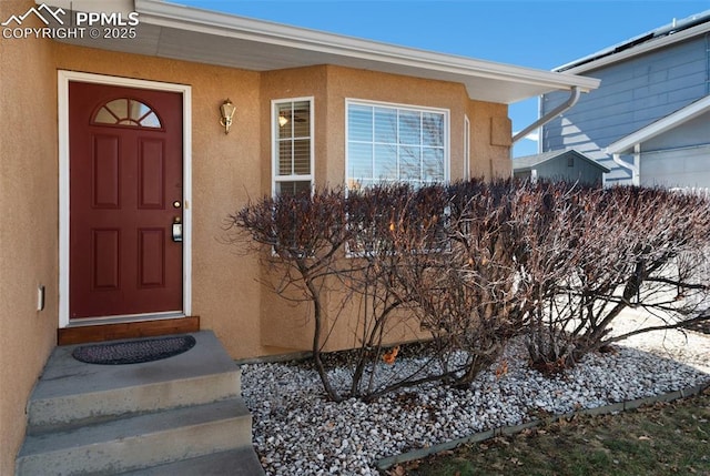 doorway to property with stucco siding