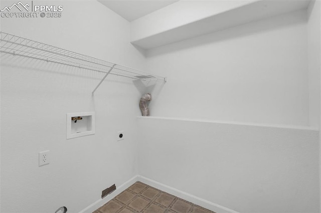 clothes washing area featuring baseboards, laundry area, hookup for a washing machine, and hookup for an electric dryer