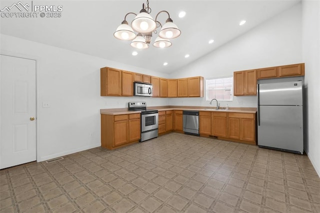 kitchen with stainless steel appliances, light countertops, a sink, and visible vents