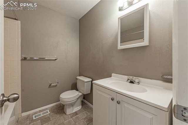 bathroom featuring toilet, vanity, visible vents, baseboards, and tub / shower combination