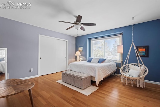 20290 Doewood Dr, Monument, CO 80132 - bedroom featuring ceiling fan, a closet, baseboards, and wood finished floors