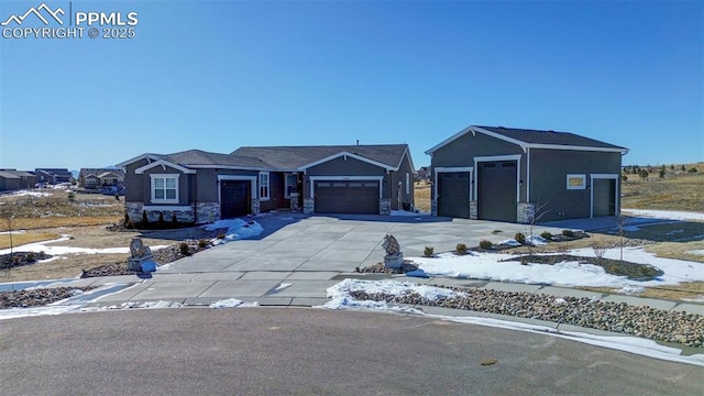 view of front of home featuring an attached garage, stone siding, concrete driveway, and stucco siding