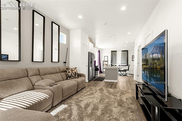 living area with recessed lighting and wood finished floors