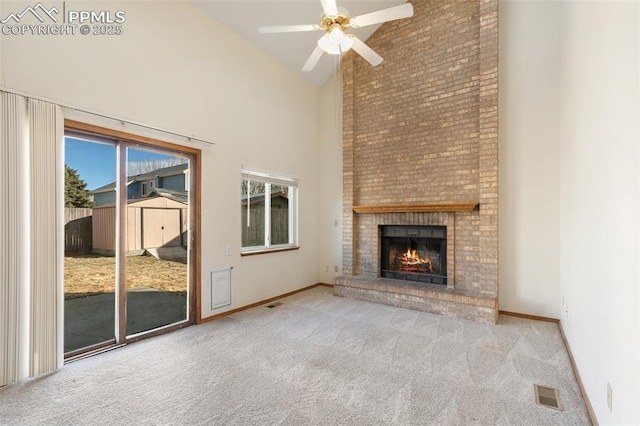 unfurnished living room with light carpet, high vaulted ceiling, a fireplace, and visible vents