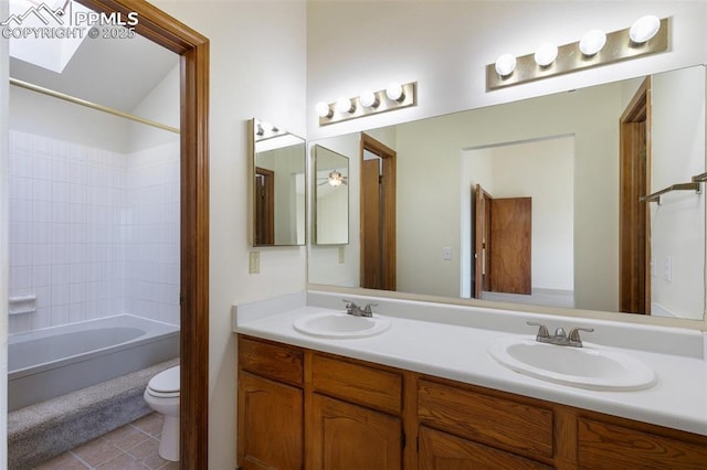 full bath featuring tile patterned floors, a sink, toilet, and double vanity